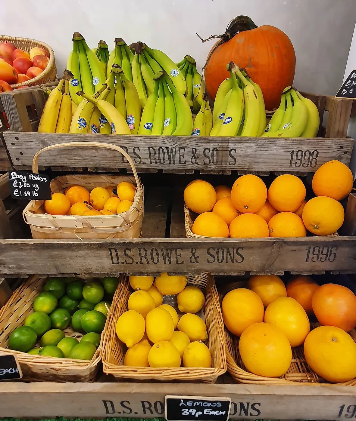 Bananas and citrus arranged in wooden crates